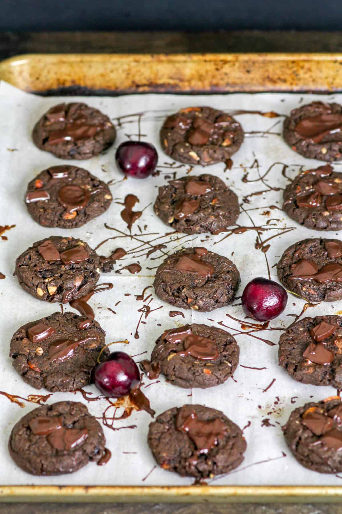 a tray of chocolate cookies with melted chocolate