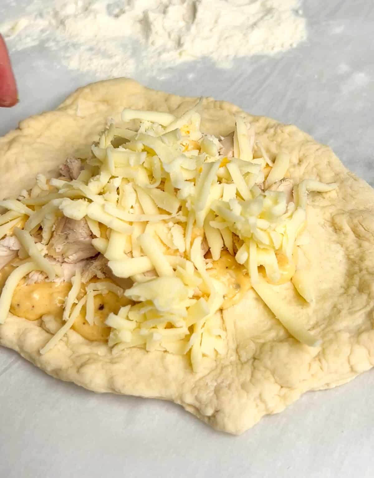 Pockets of dough are stuffed with your favorite pizza toppings, sauce, and cheese in these super easy Air Fryer Calzones. Pizza dough topped with chicken alfredo toppings