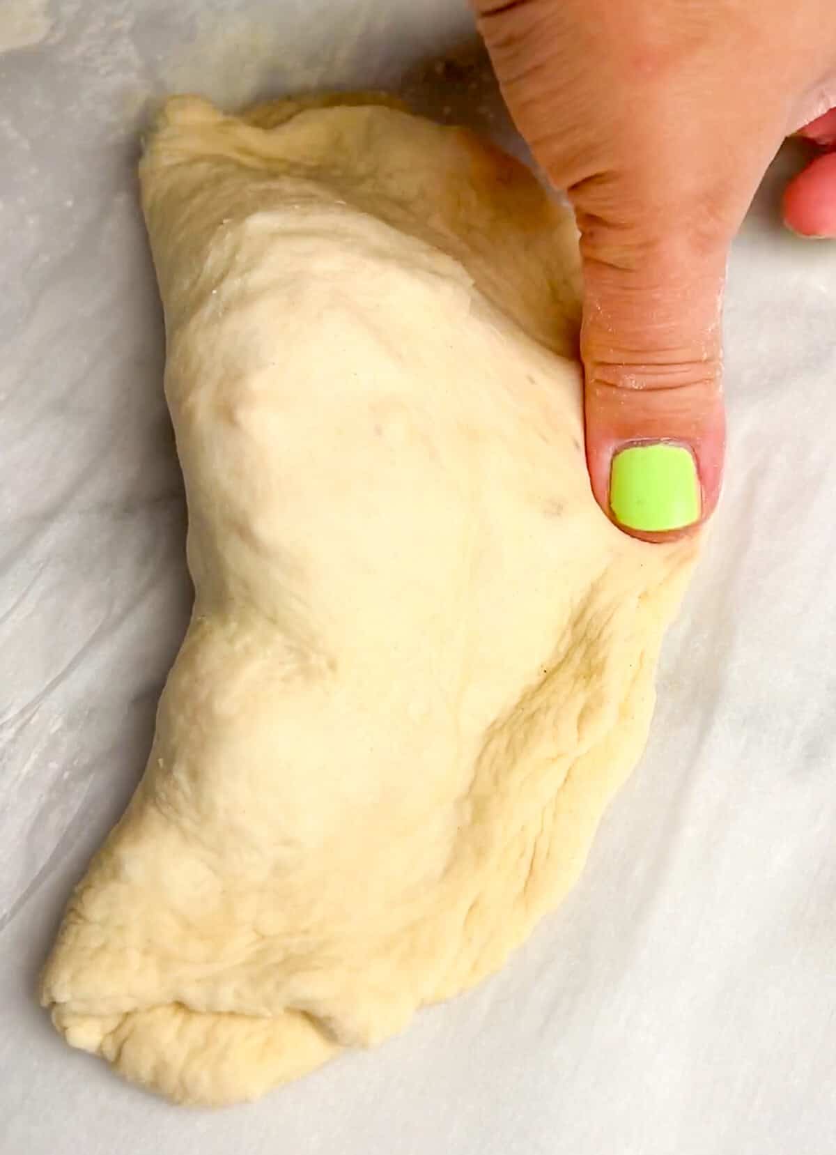 Pockets of dough are stuffed with your favorite pizza toppings, sauce, and cheese in these super easy Air Fryer Calzones. Pressing the edges of a calzone to seal