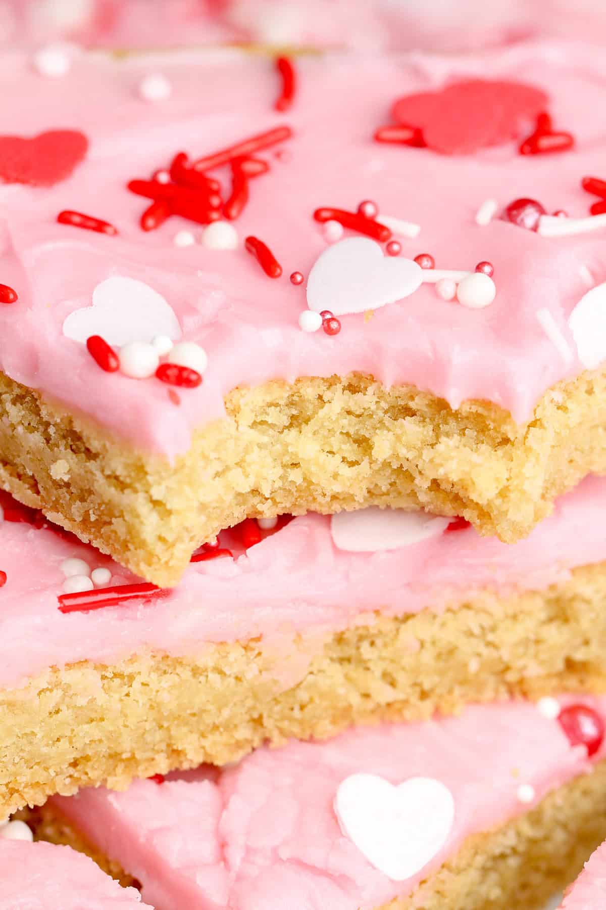 A stack of frosted sugar cookie bars