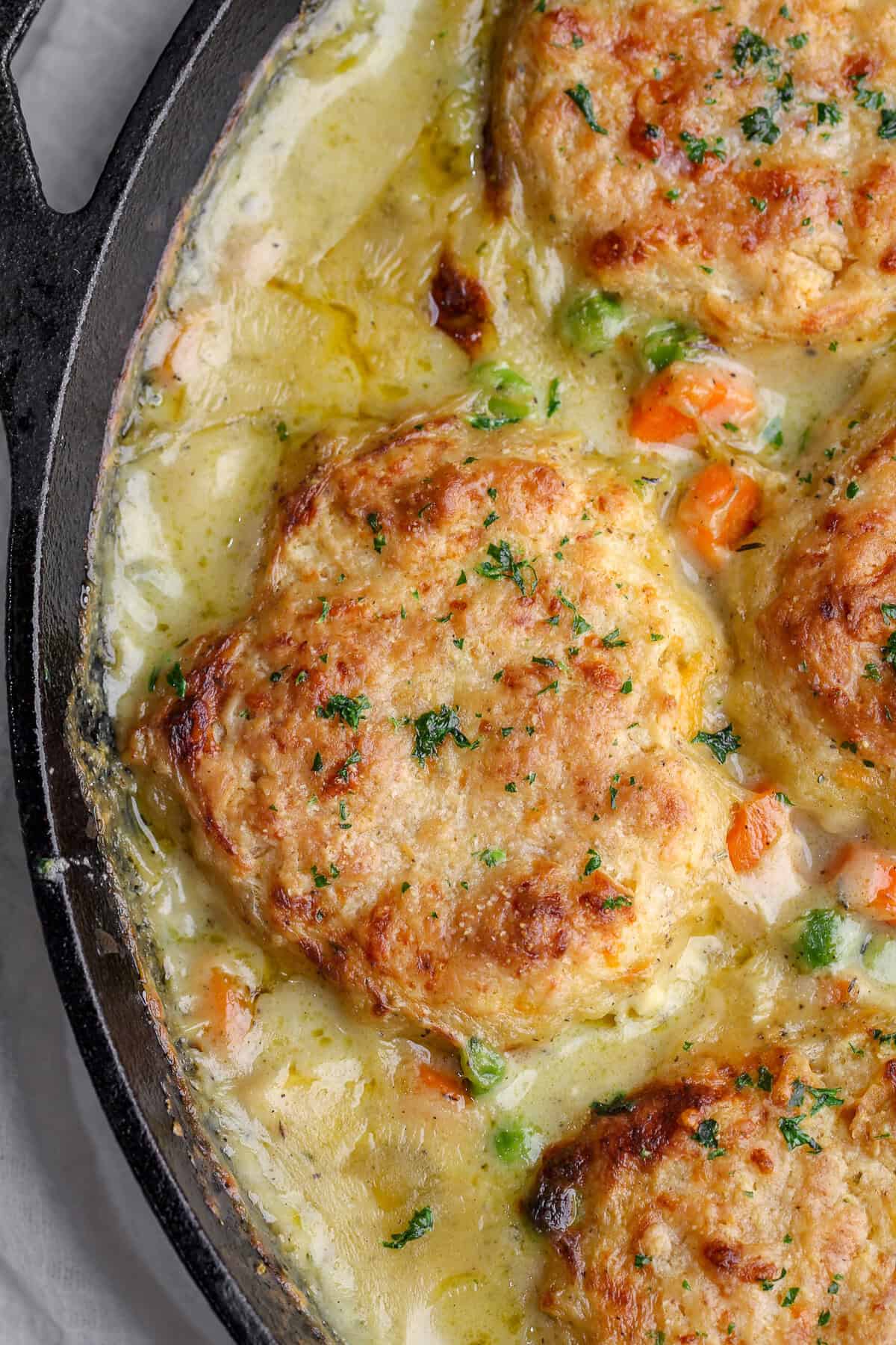 The best chicken pot pie with biscuits. But not just any biscuits, from-scratch Red Lobster cheddar bay biscuits full of cheesy goodness! Close-up overhead image of Cheddar Bay Biscuit Chicken Pot Pie.