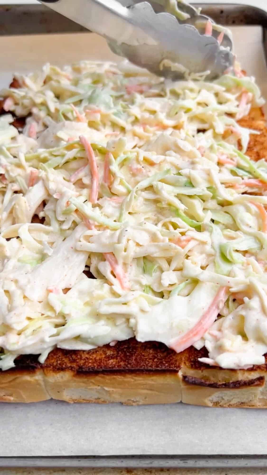 Shredded BBQ chicken, coleslaw tossed in Alabama white sauce, and crunchy chips make these BBQ Chicken Sliders unforgettable. Coleslaw spread on toasted slider buns