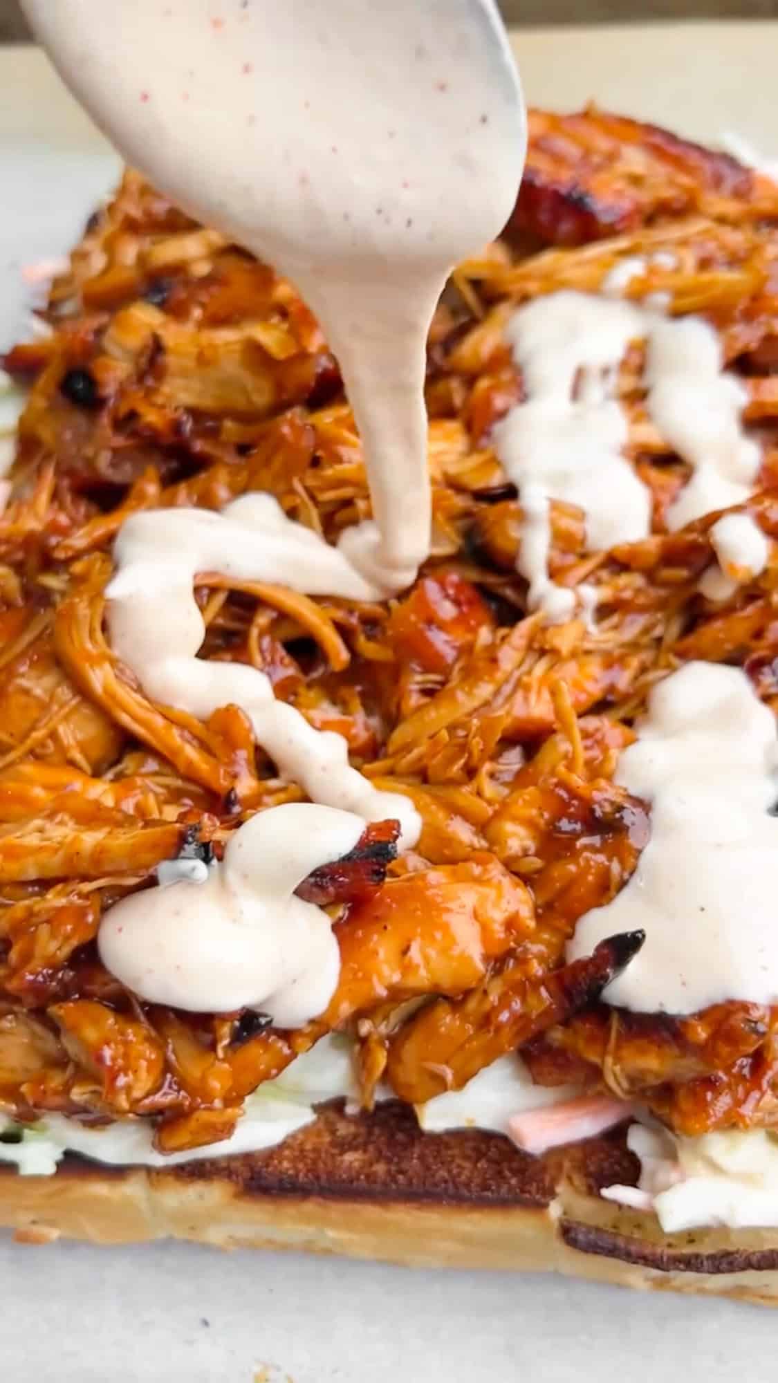 Shredded BBQ chicken, coleslaw tossed in Alabama white sauce, and crunchy chips make these BBQ Chicken Sliders unforgettable. Drizzling Alabama white sauce over BBQ chicken on sliders