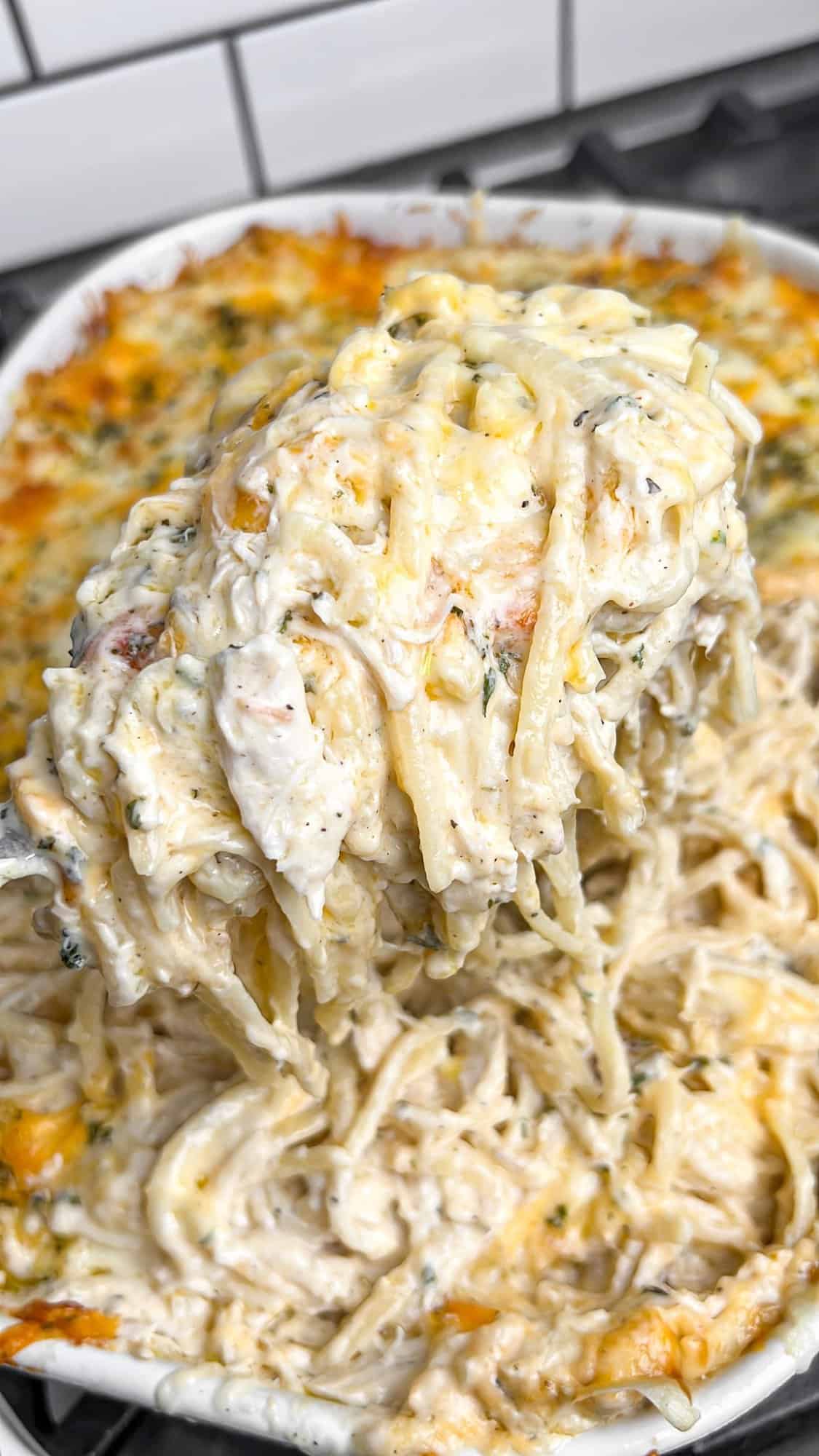 Lusciously creamy, cheesy, and garlicky, this easy chicken tetrazzini can be whipped up in under an hour for an easy weeknight dinner. Serving a scoop of chicken tetrazzini