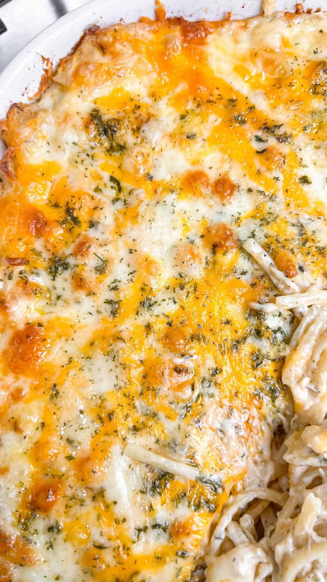 Lusciously creamy, cheesy, and garlicky, this easy chicken tetrazzini can be whipped up in under an hour for an easy weeknight dinner. Overhead view of a baking dish of chicken tetrazzini