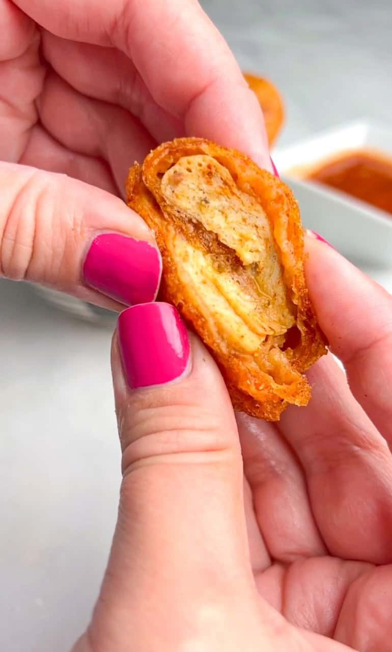 A spicy version of McDonald's Chicken Nugget recipe and Mighty Hot Sauce. These spicy chicken nuggets are super crispy, juicy and addictive. A hand holding a copycat McDonald's chicken nugget showing the inside