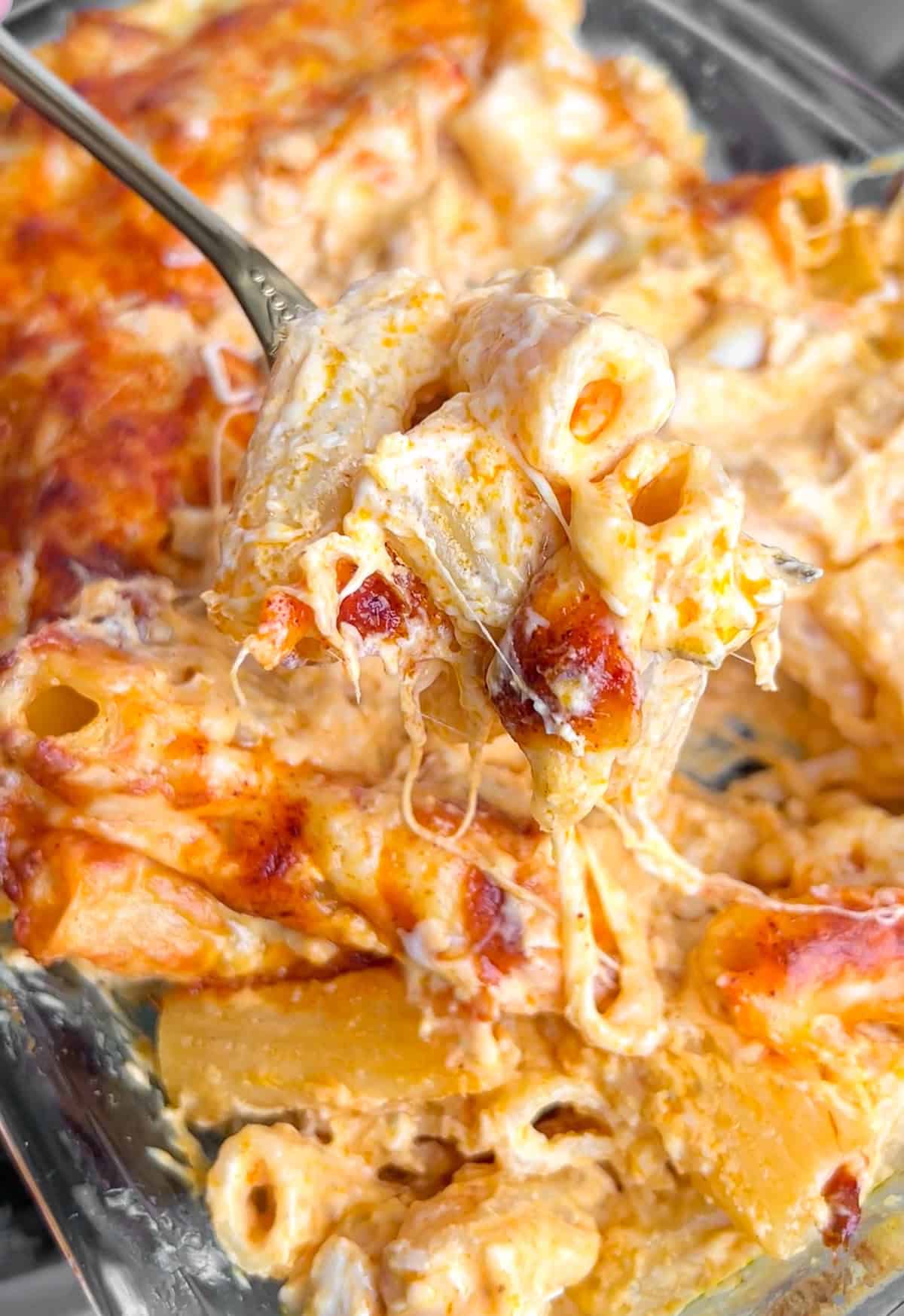 This Buffalo Chicken Mac and Cheese turns the classic appetizer dip into a full meal. Ready in 30 minutes with just 6 main ingredients. A spoon diving into buffalo chicken mac and cheese