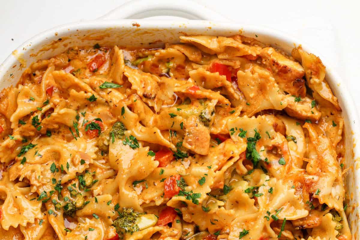 Inspired by the Cheesecake Factory, this Louisiana Chicken Pasta Bake is a cajun alfredo chicken pasta with veggies smothered in cheese. Louisiana Chicken Pasta in a casserole dish