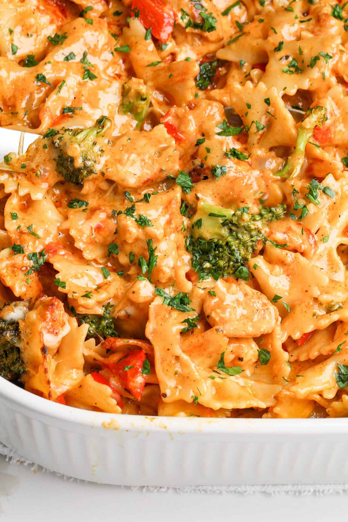 Inspired by the Cheesecake Factory, this Louisiana Chicken Pasta Bake is a cajun alfredo chicken pasta with veggies smothered in cheese. Louisiana chicken pasta in a baking dish