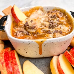 A bowl of caramel apple dip topped with toffee