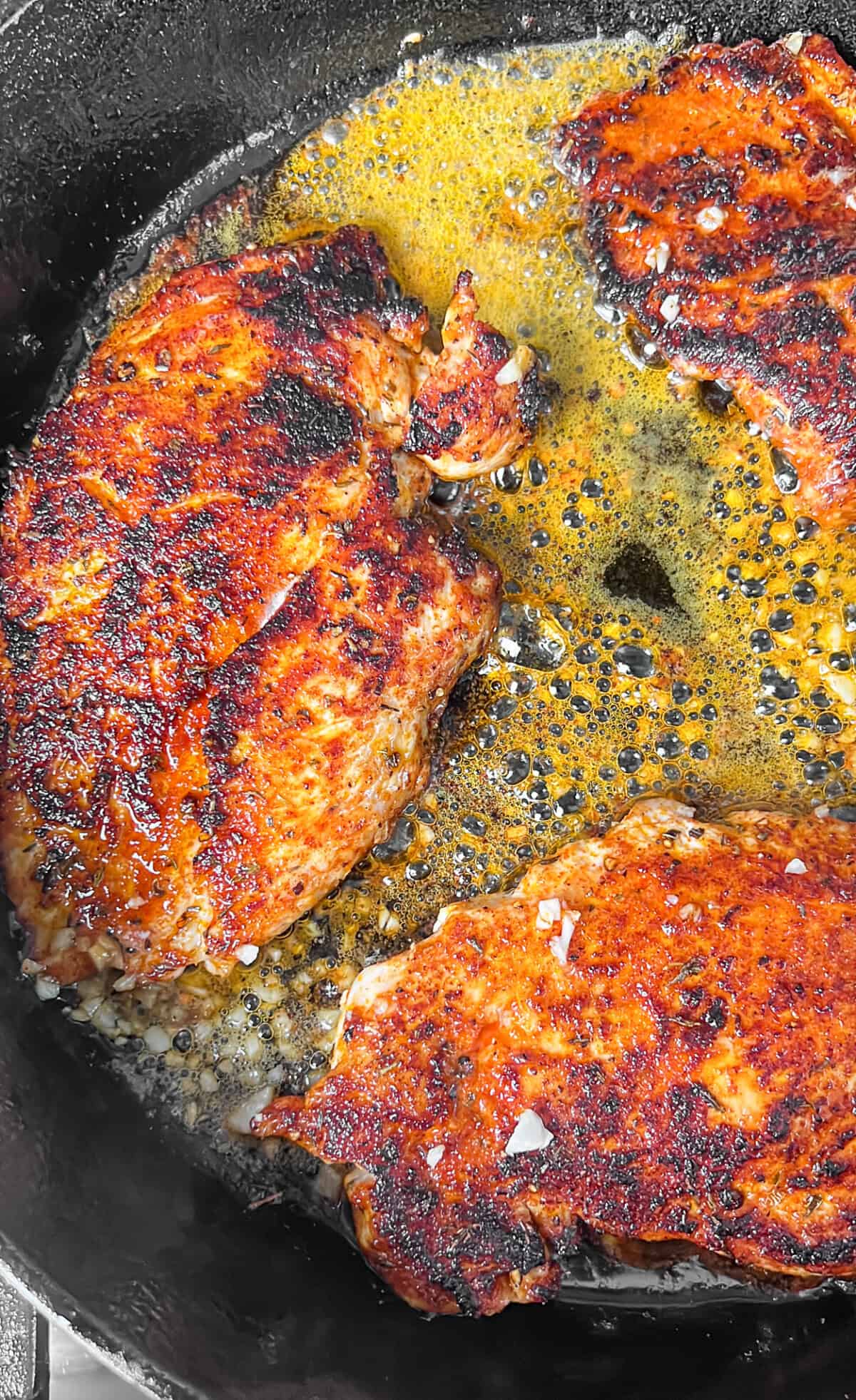 With juicy blackened chicken and a garlicky seasoned alfredo sauce, Blackened Chicken Alfredo is a quick and easy weeknight dinner. Blackened chicken breasts cooking in a skillet