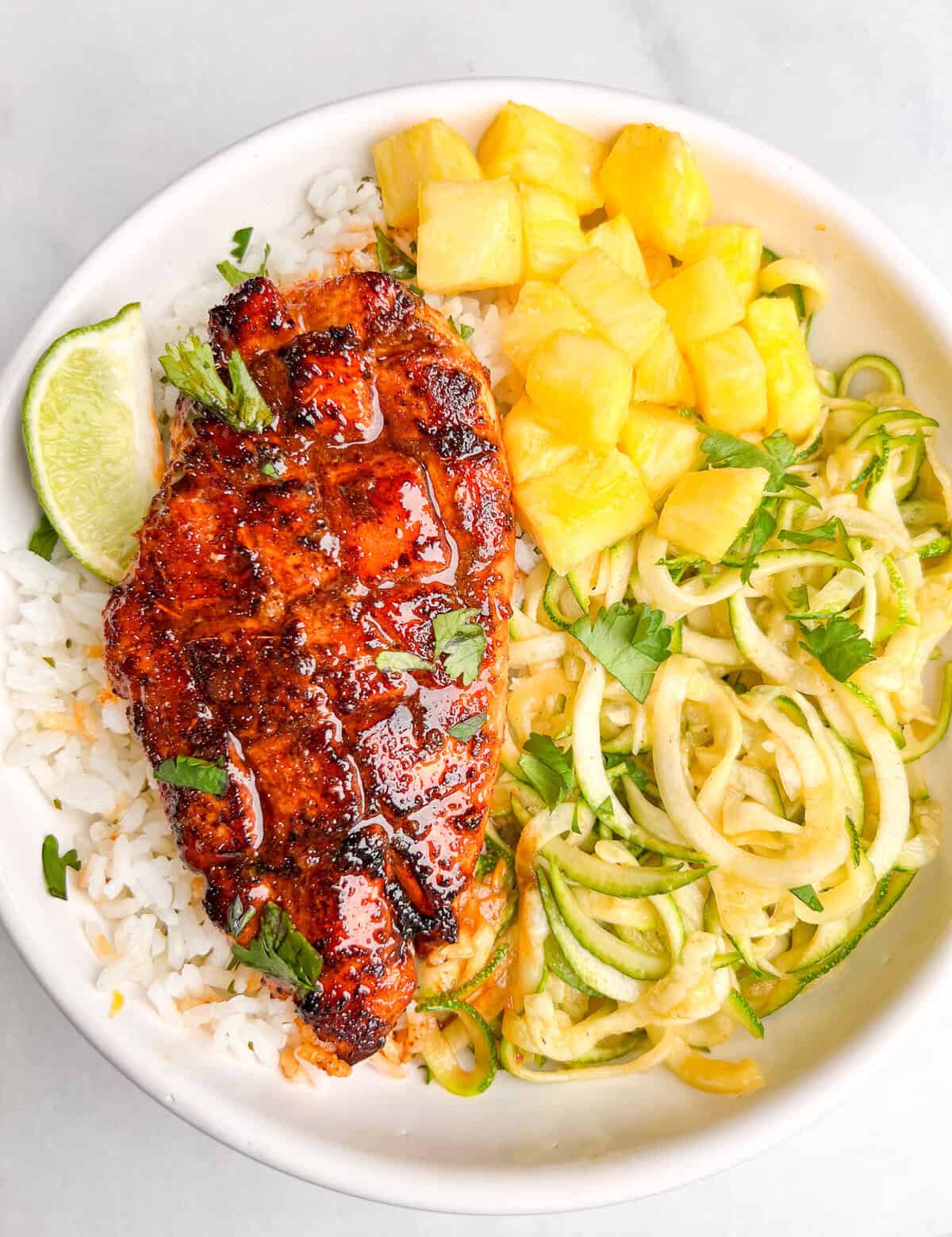 Equal parts sweet and spicy, this Honey Chipotle Chicken is a quick, easy one-pan recipe that results in juicy, flavorful chicken every time. Overhead view of a plate of honey chipotle chicken over rice