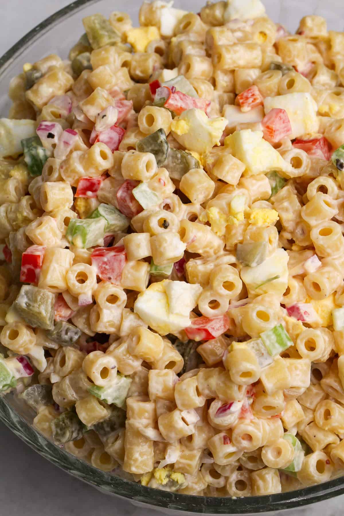 This is the best macaroni salad recipe ever. Sweet, tangy, creamy, and the perfect side dish for cookouts and summer gatherings. Close-up overhead image of the best macaroni salad.