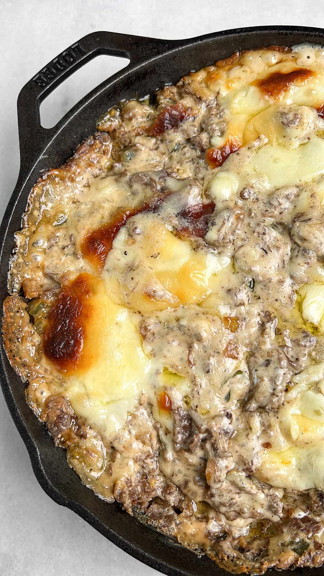 cheese dip with steak in a skillet