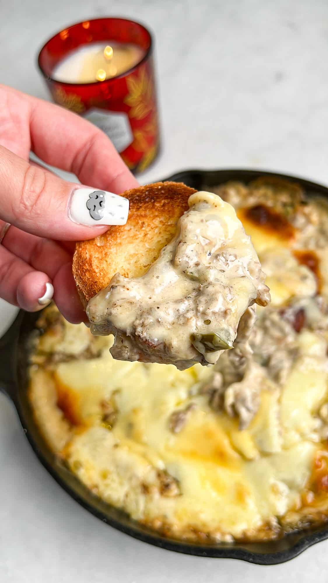 cheese and steak dip in a cast iron