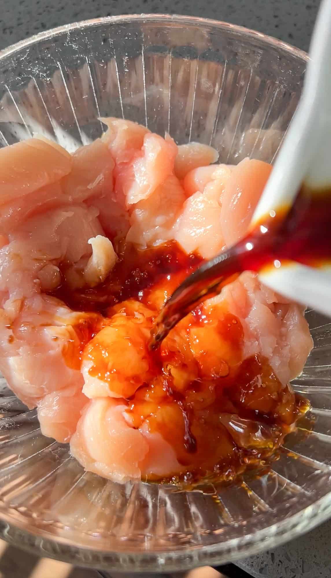 chicken marinading in a bowl