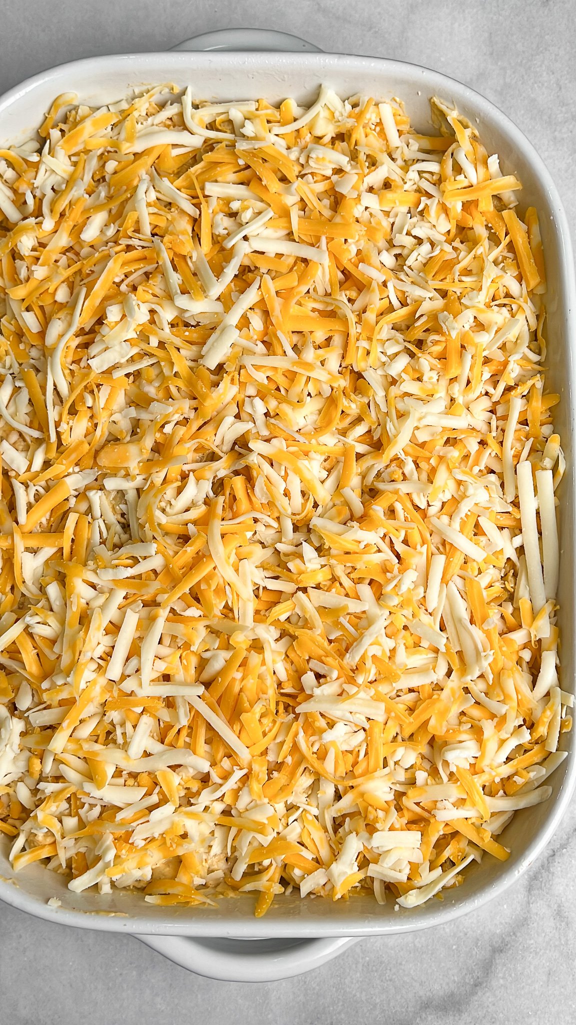 shredded cheese layered on macaroni