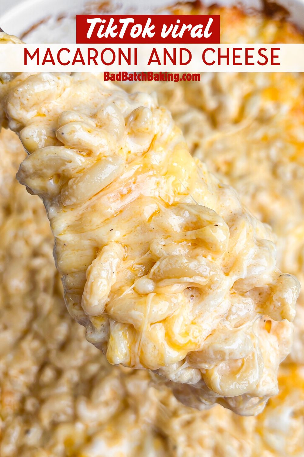 macaroni and cheese being lifted out of a pan with a spoon