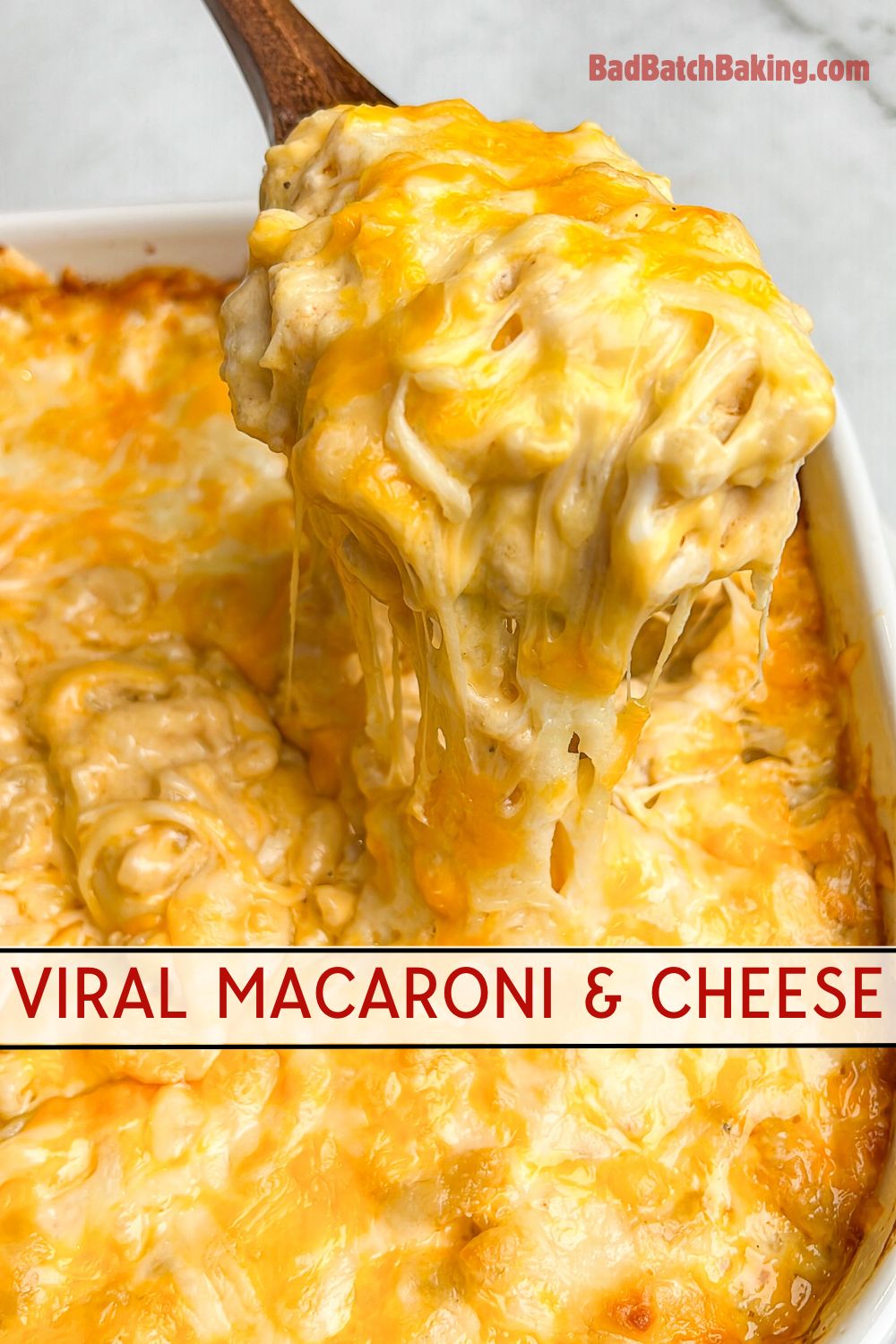 macaroni and cheese being lifted out of a pan with a spoon