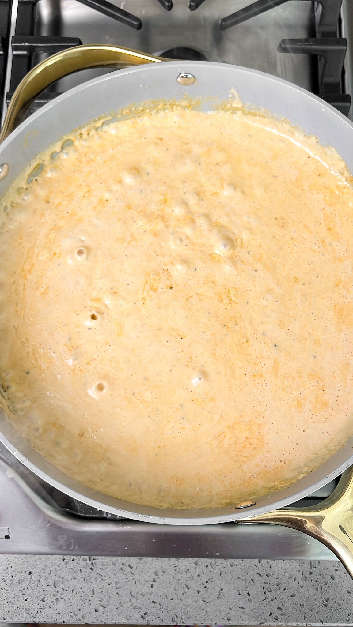 bringing the cream sauce to a low boil