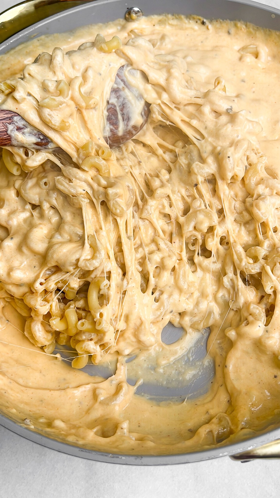 macaroni and cheese sauce mixing together in a pan