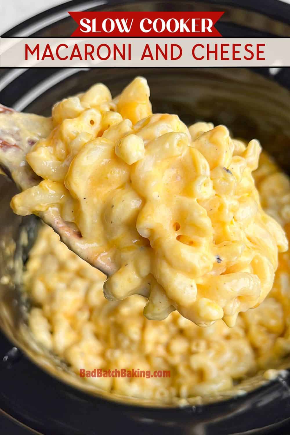 creamy mac and cheese in a slow cooker on a spoon