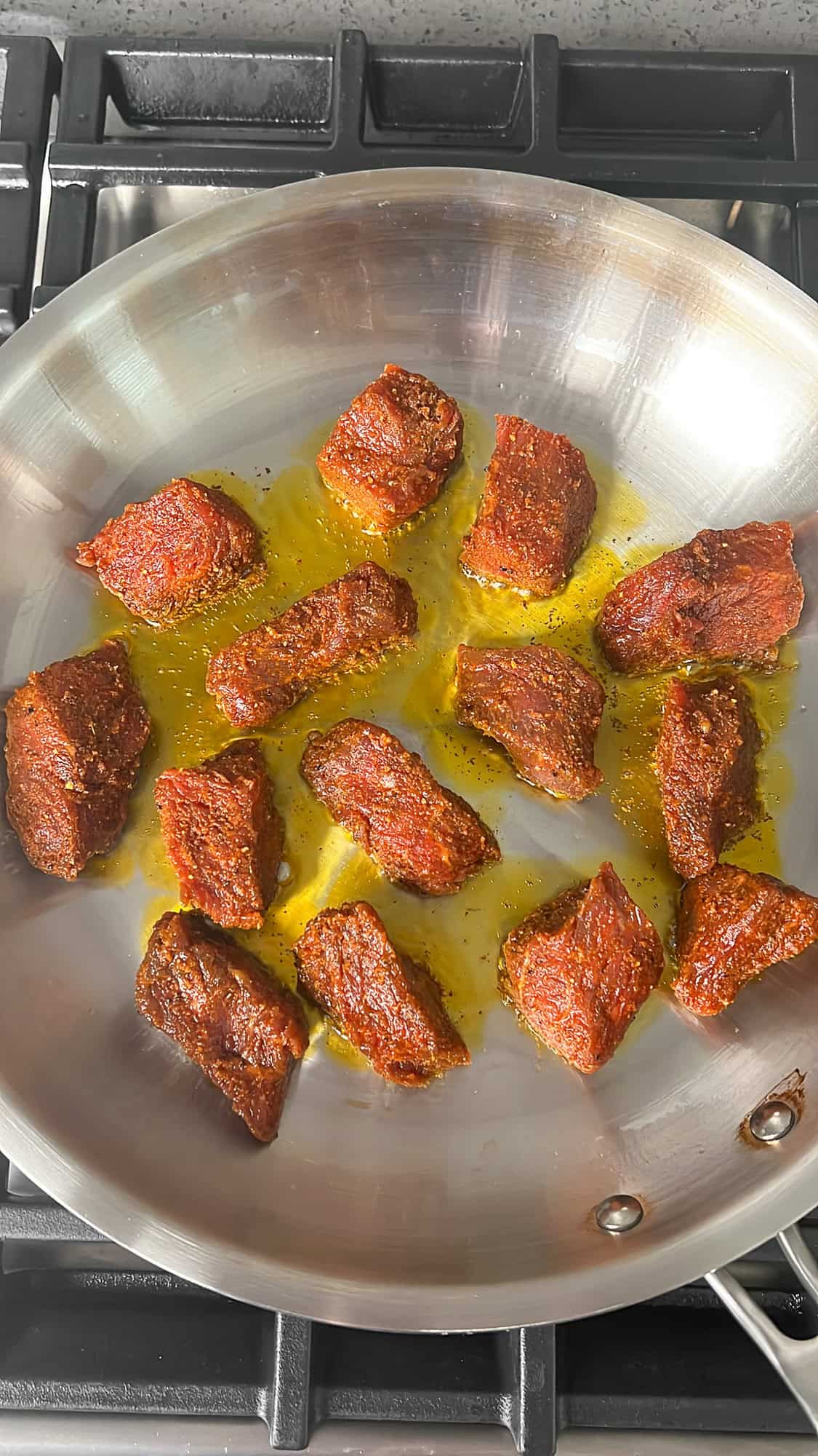 seasoned steak frying in a pan