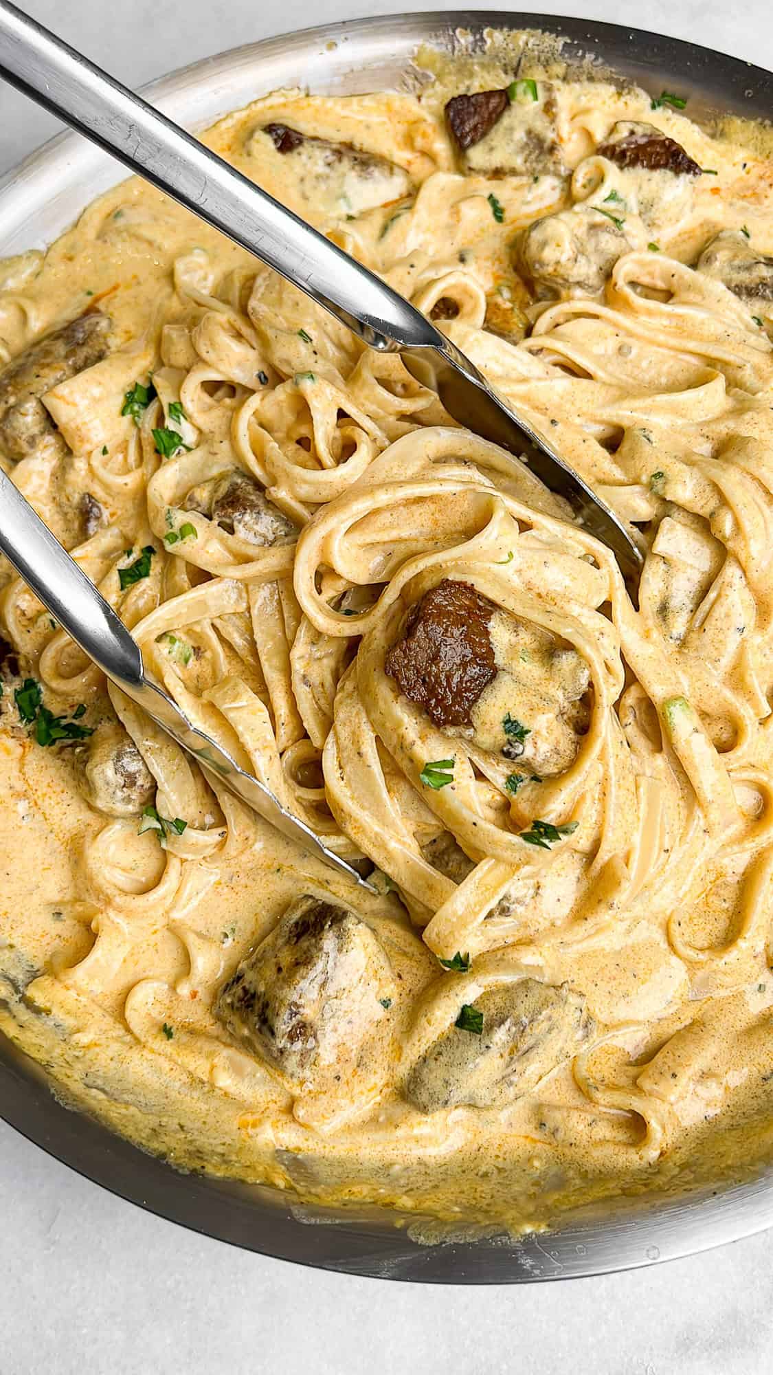 steak alfredo in a pan