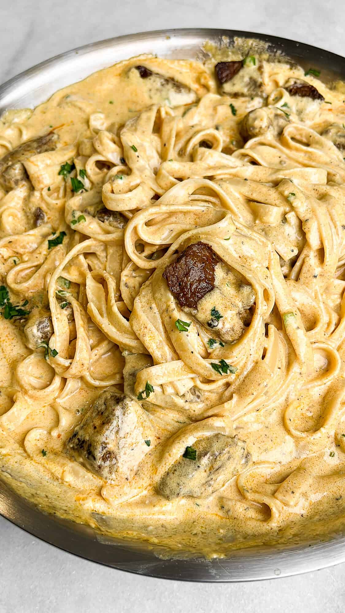 creamy steak fettuccini alfredo in a pan