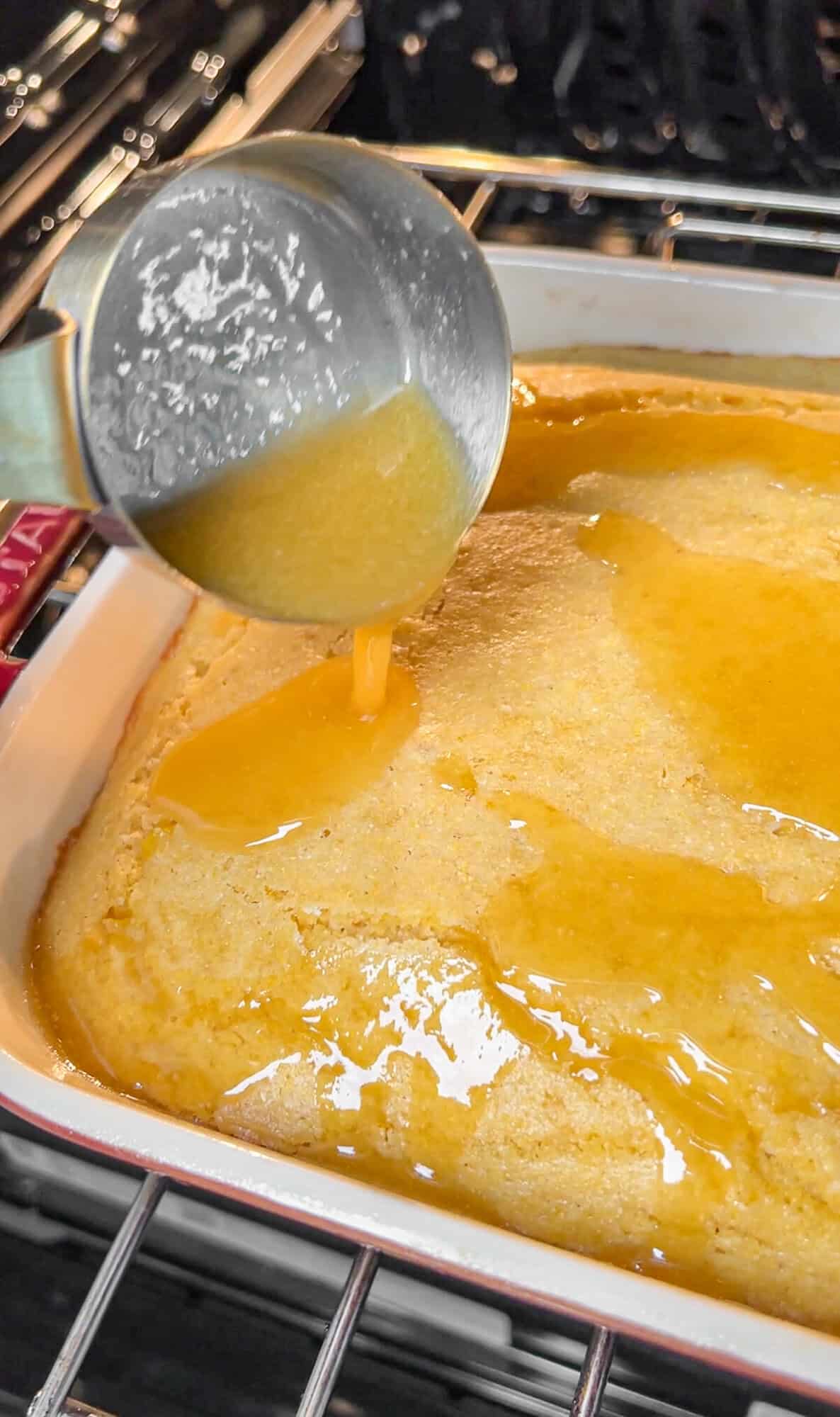 pouring melted honey butter on the cornbread