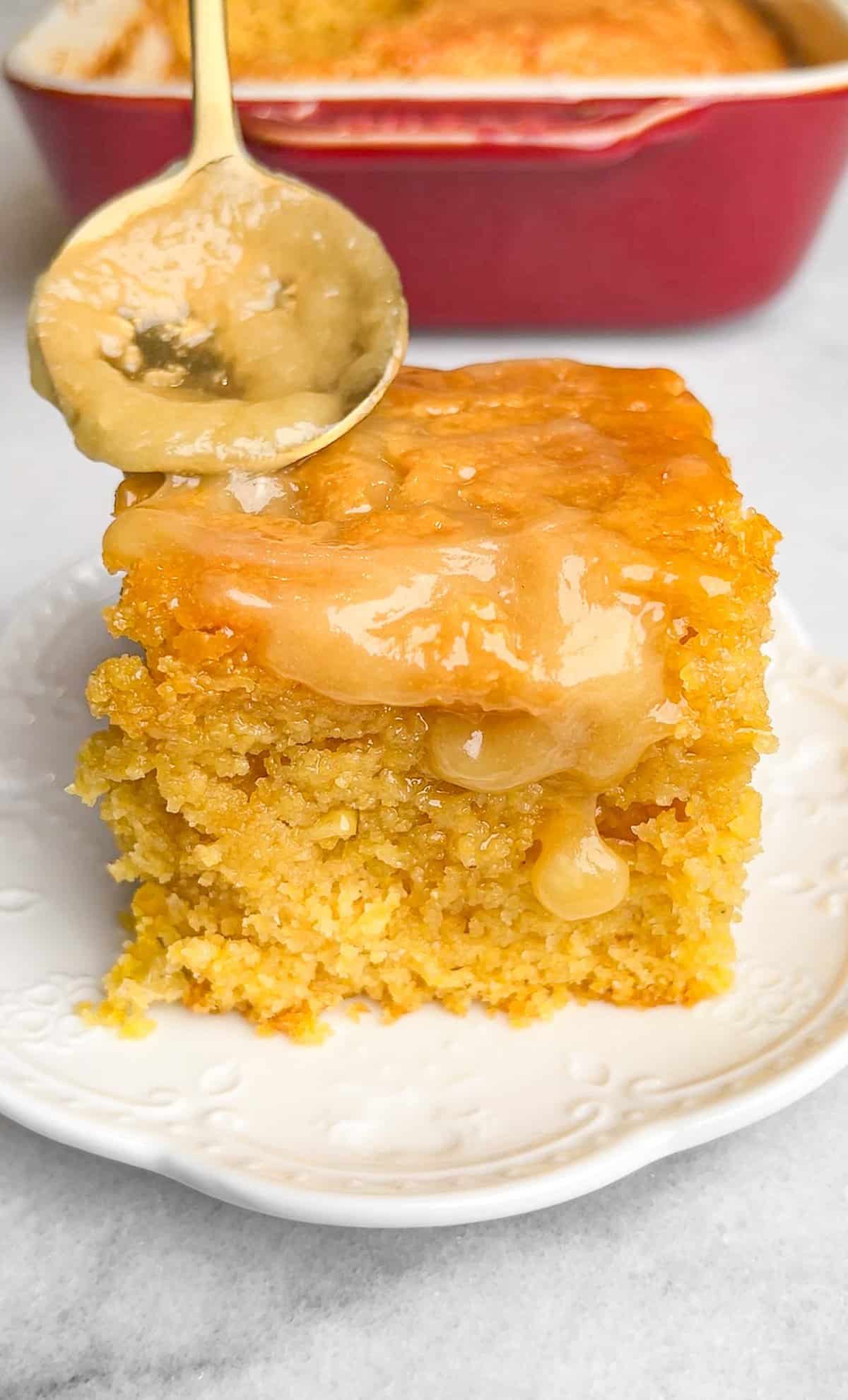 This moist, tender honey butter cornbread is full of real corn flavor and doused in a buttery, sticky glaze. It's ready for the holidays. Spreading honey butter over a slice of cornbread.
