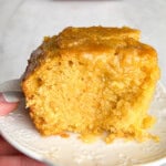 A big hunk of honey butter cornbread on a plate.