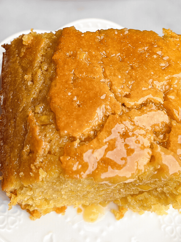 a slice of honey butter cornbread on a plate