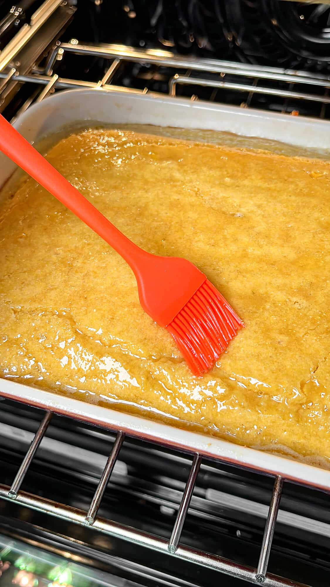 spreading honey butter on the cornbread