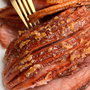 sliced ham being grabbed by a fork