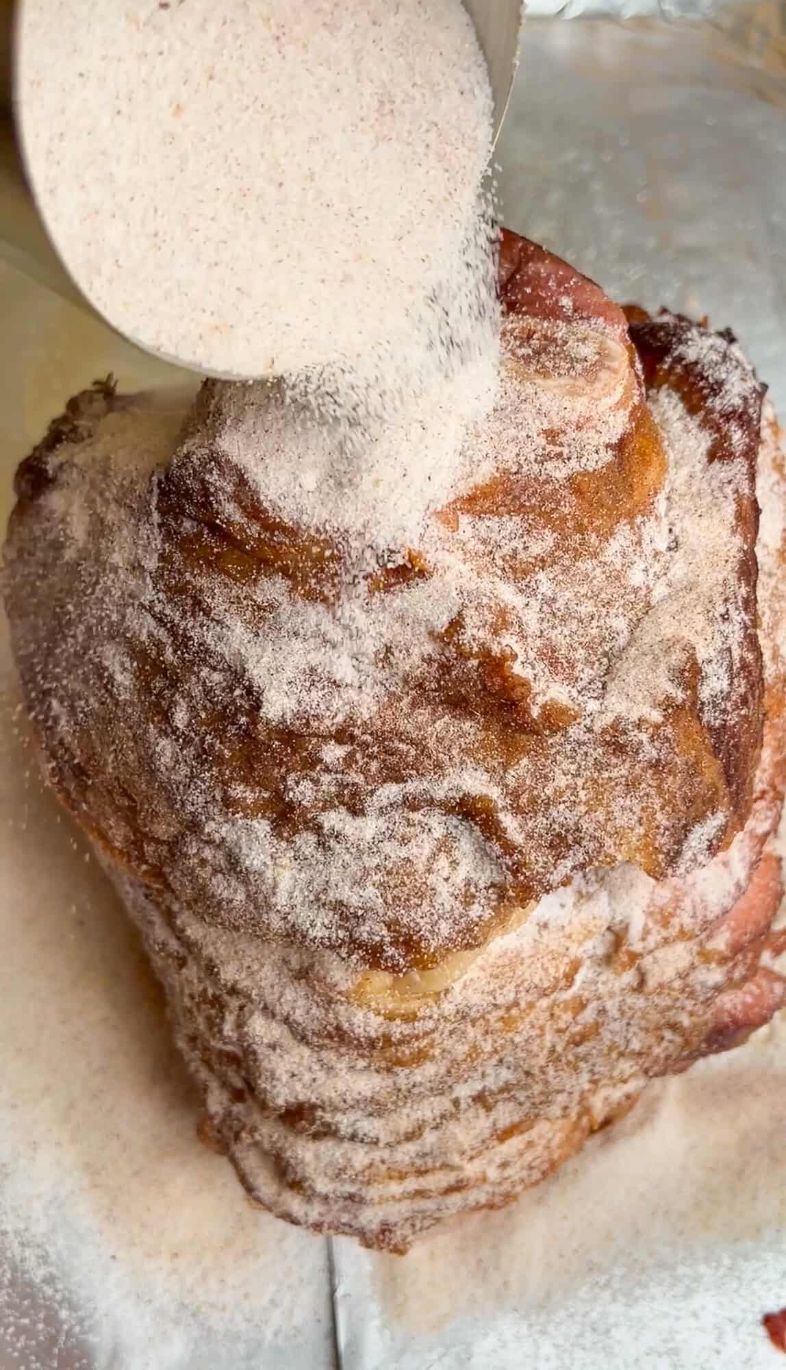 sugar pouring over ham on a pan