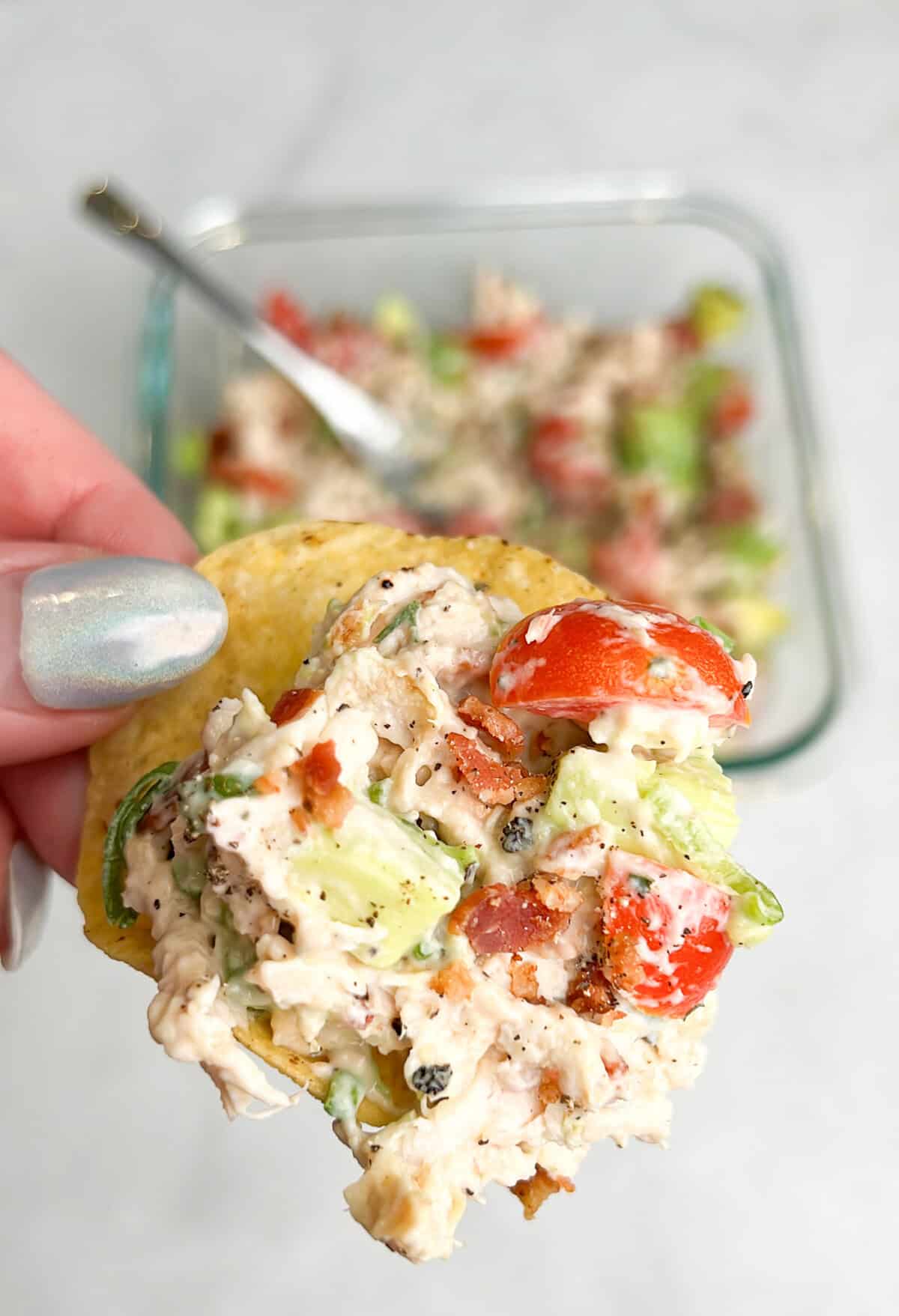 chicken salad scooped into a tortilla chip