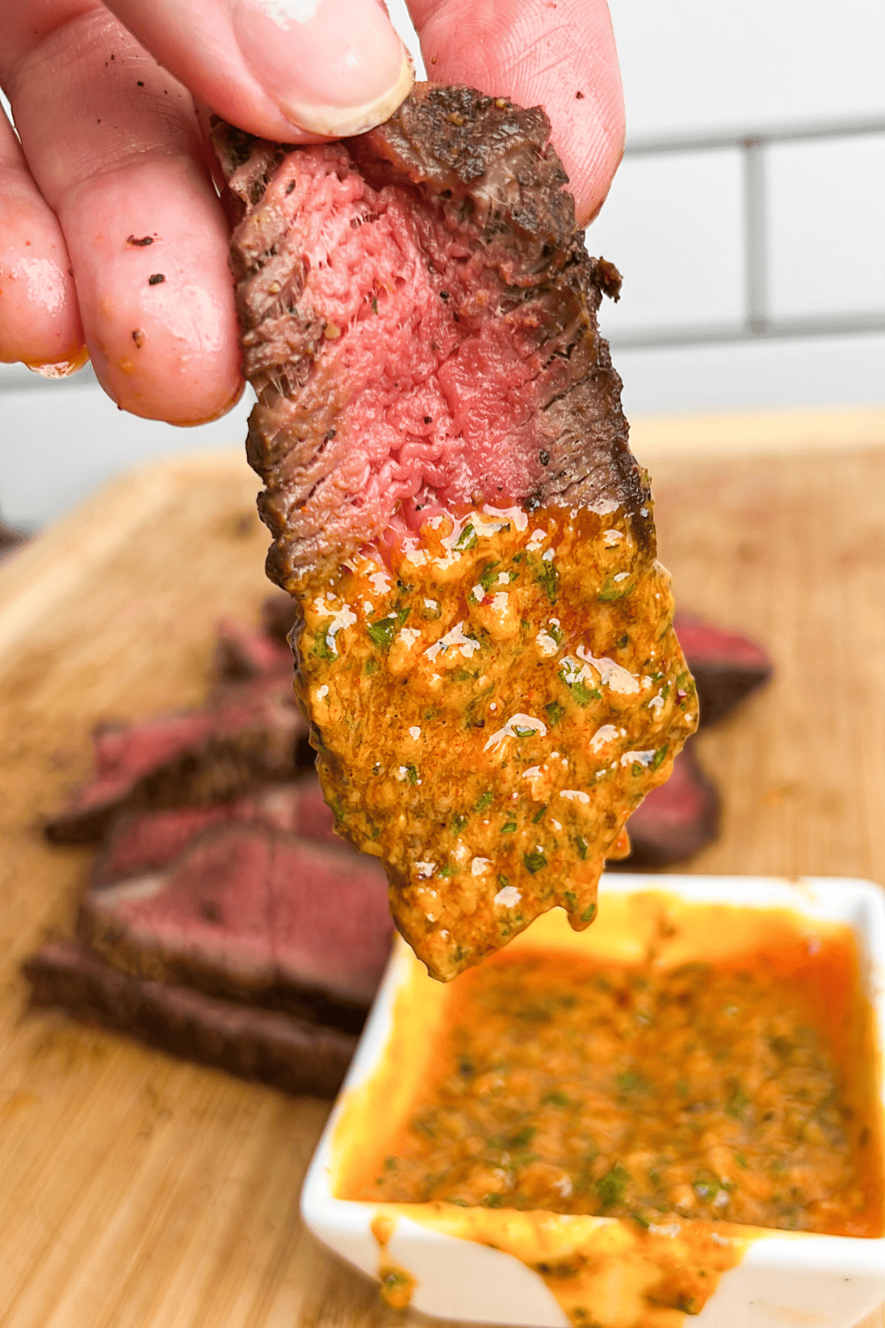 slice of steak dipping into cowboy butter