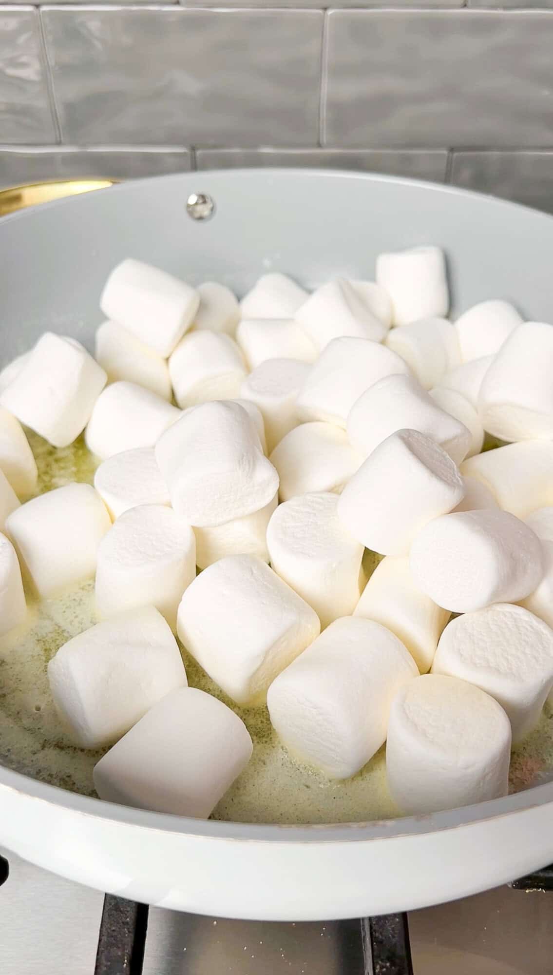 marshmallows added into melted butter in a pan