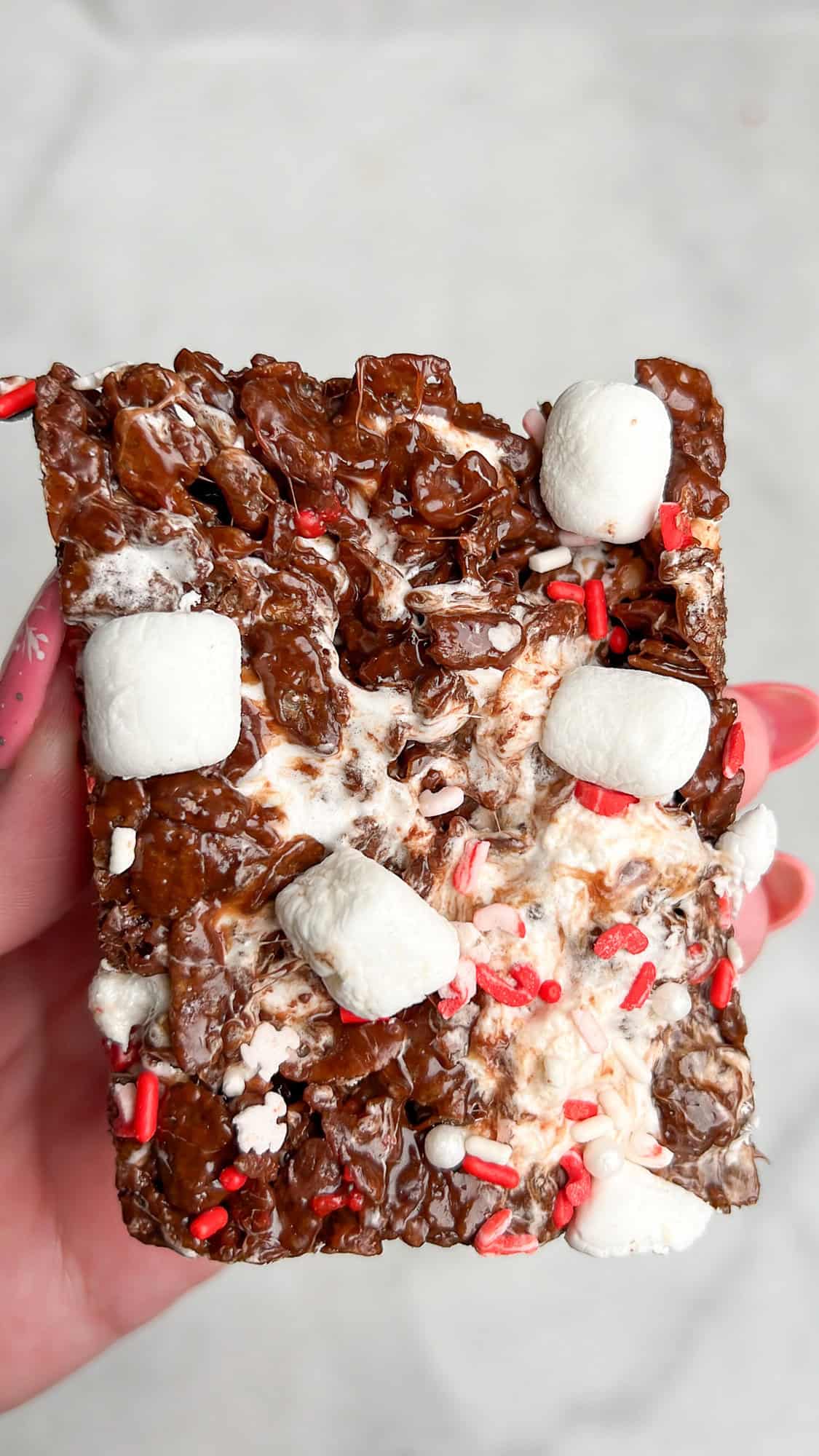 hot cocoa rice krispie treats held in hand