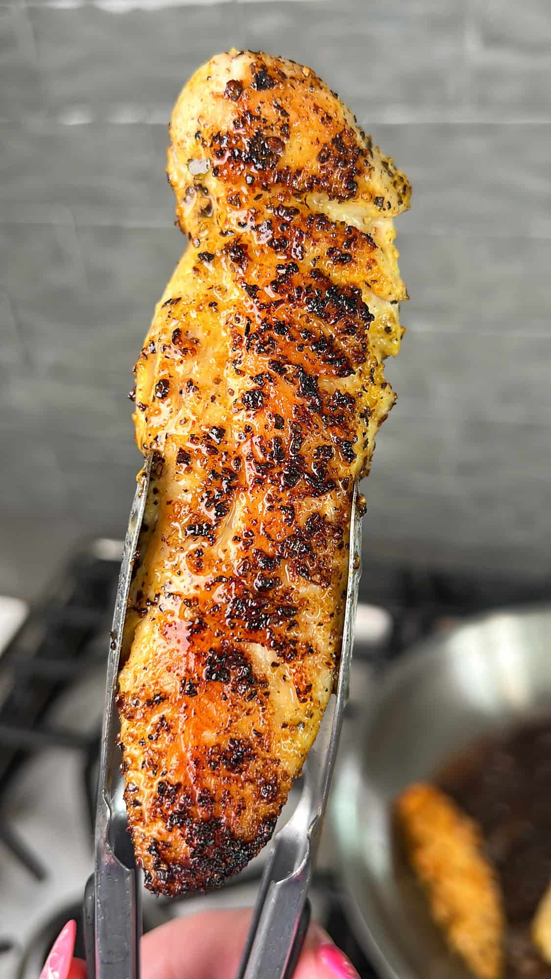 cooked lemon pepper chicken tender up close picture