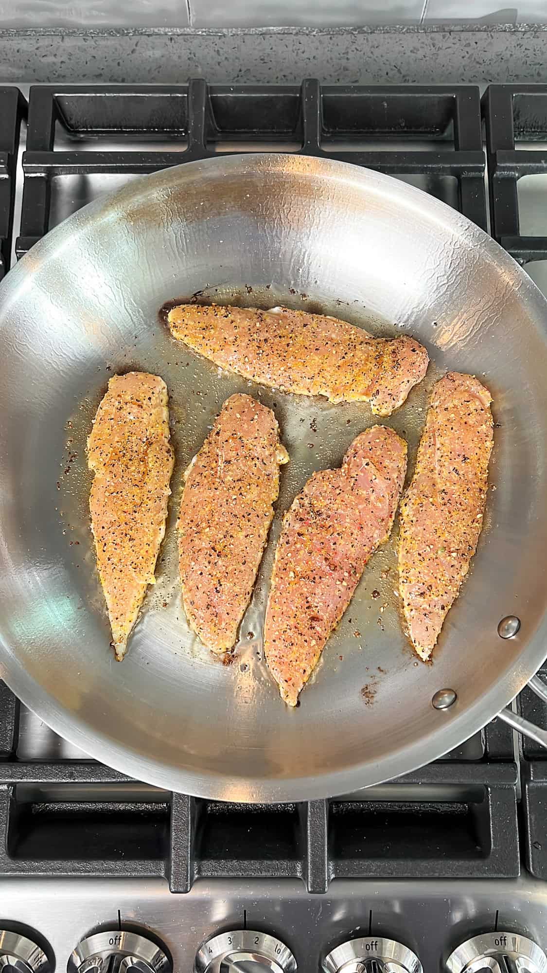 lemon pepper seasoned chicken in a skillet