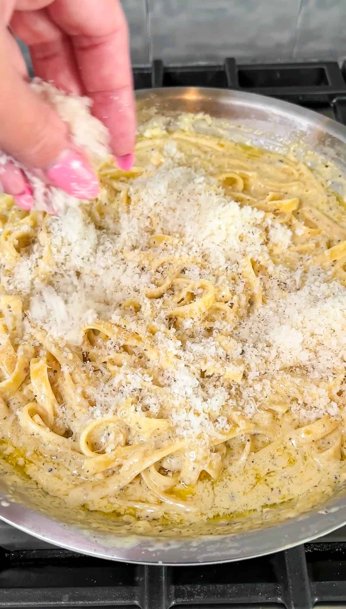 parmesan being sprinkled in the pasta