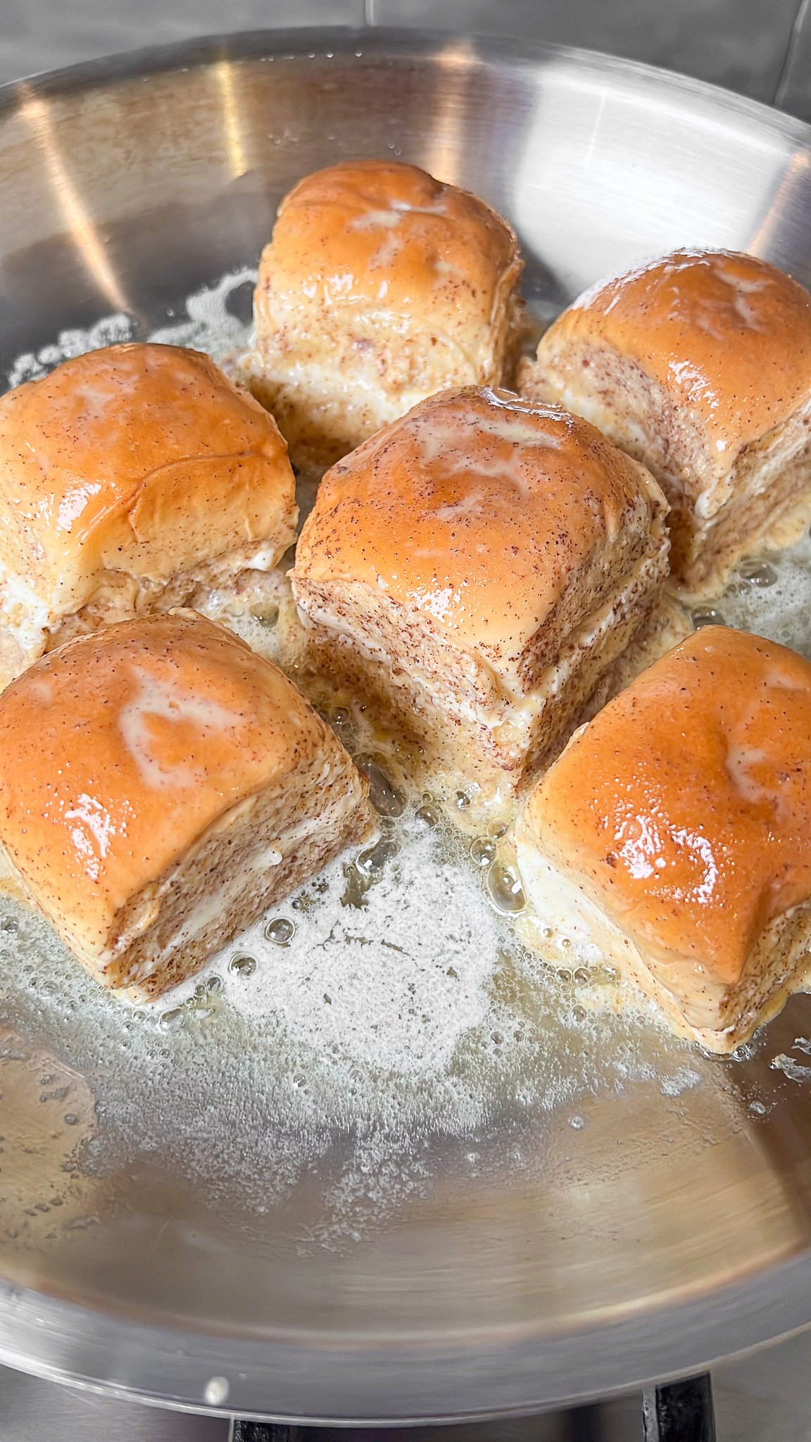 hawaiian roll french toast in a pan with butter