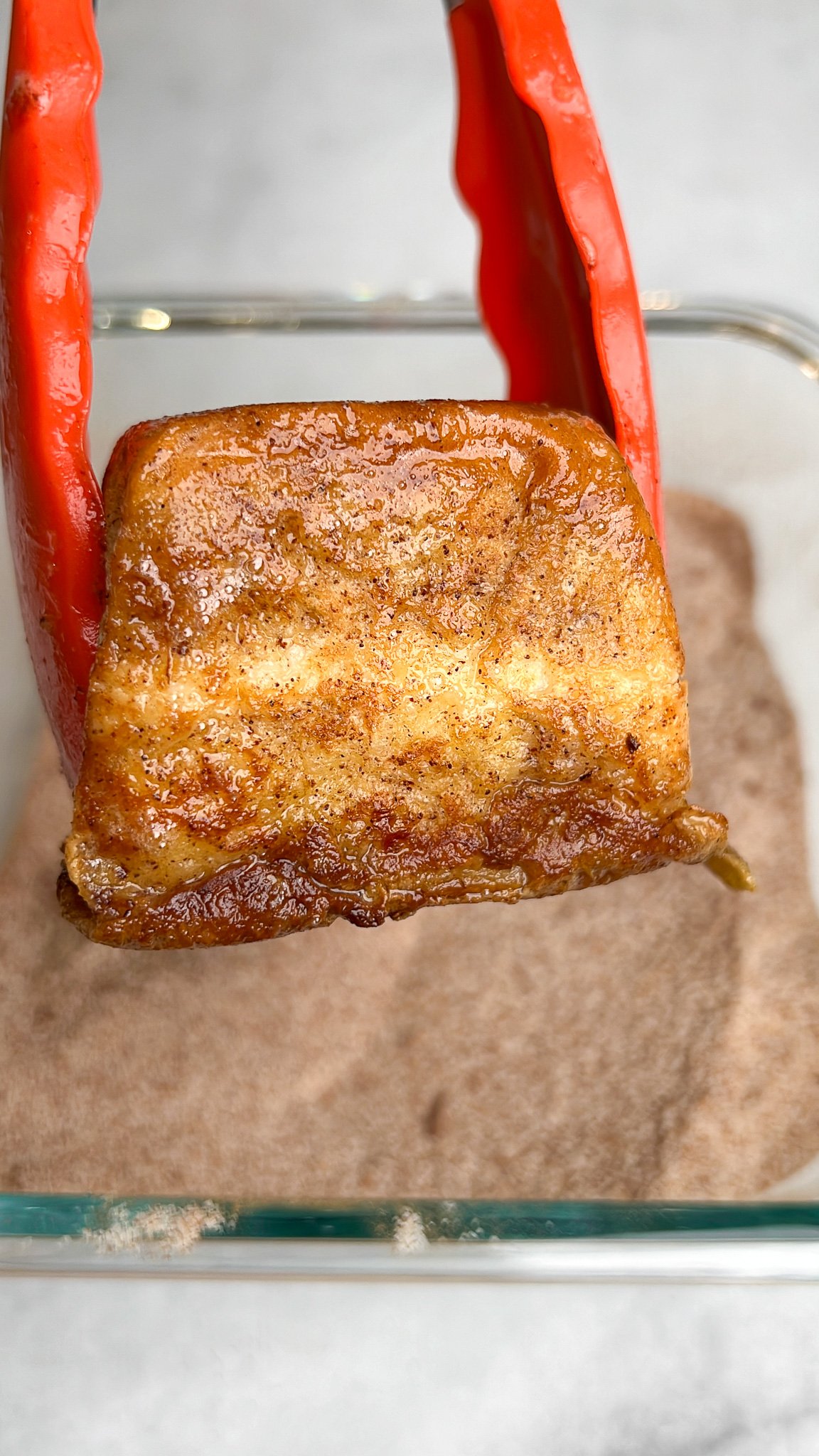 hawaiian roll french toast being tossed in cinnamon sugar