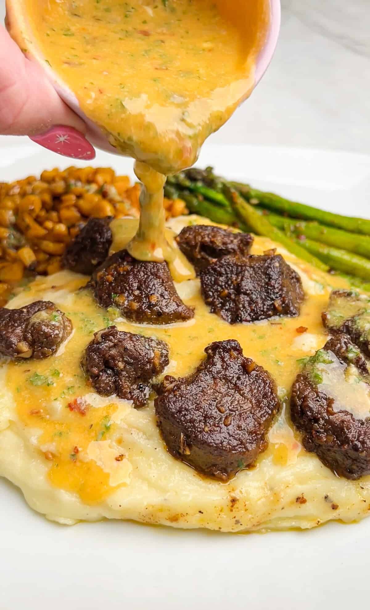 steak bites with mashed potatoes drizzled in cowboy butter