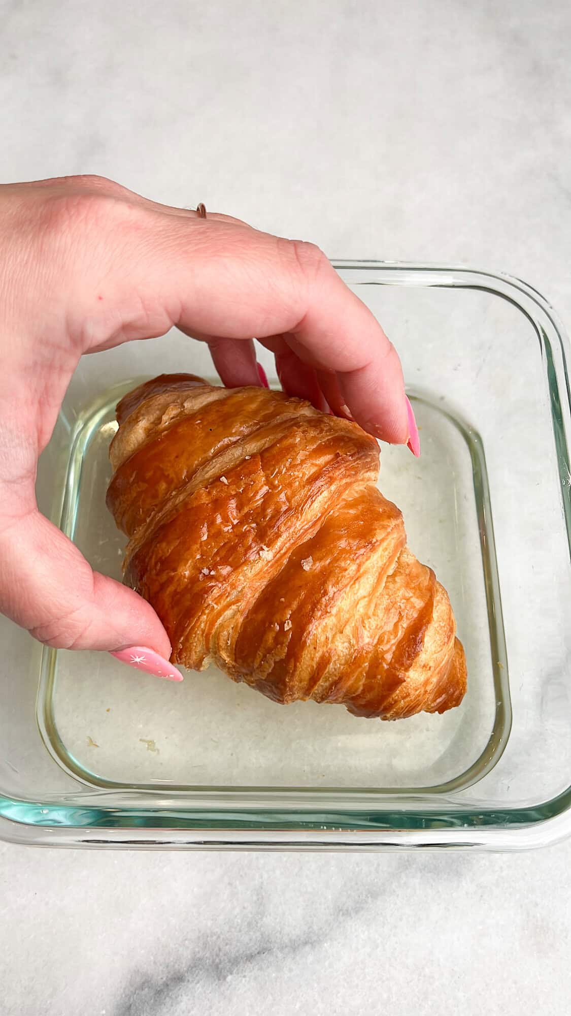 dipping croissants into simple syrup