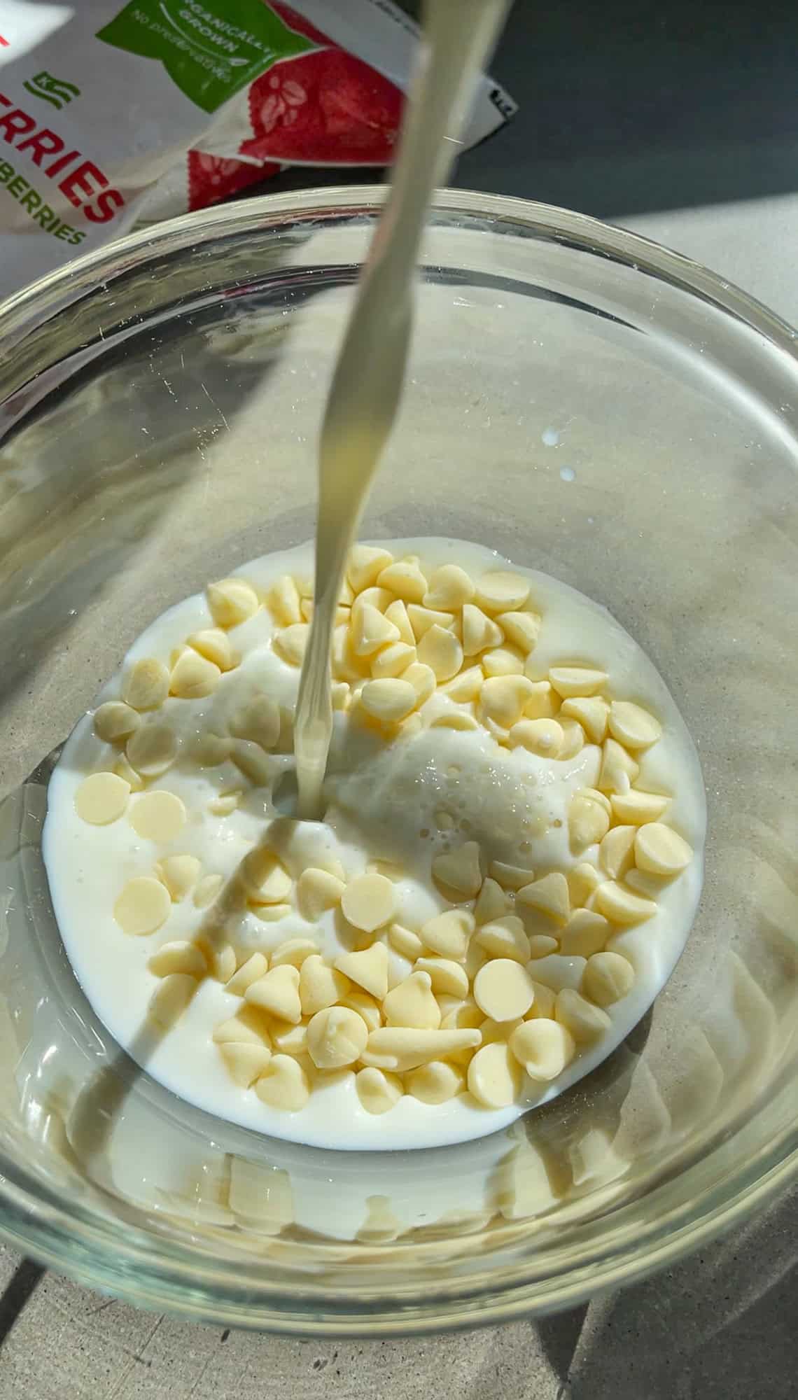 pouring hot milk over the white chocolate