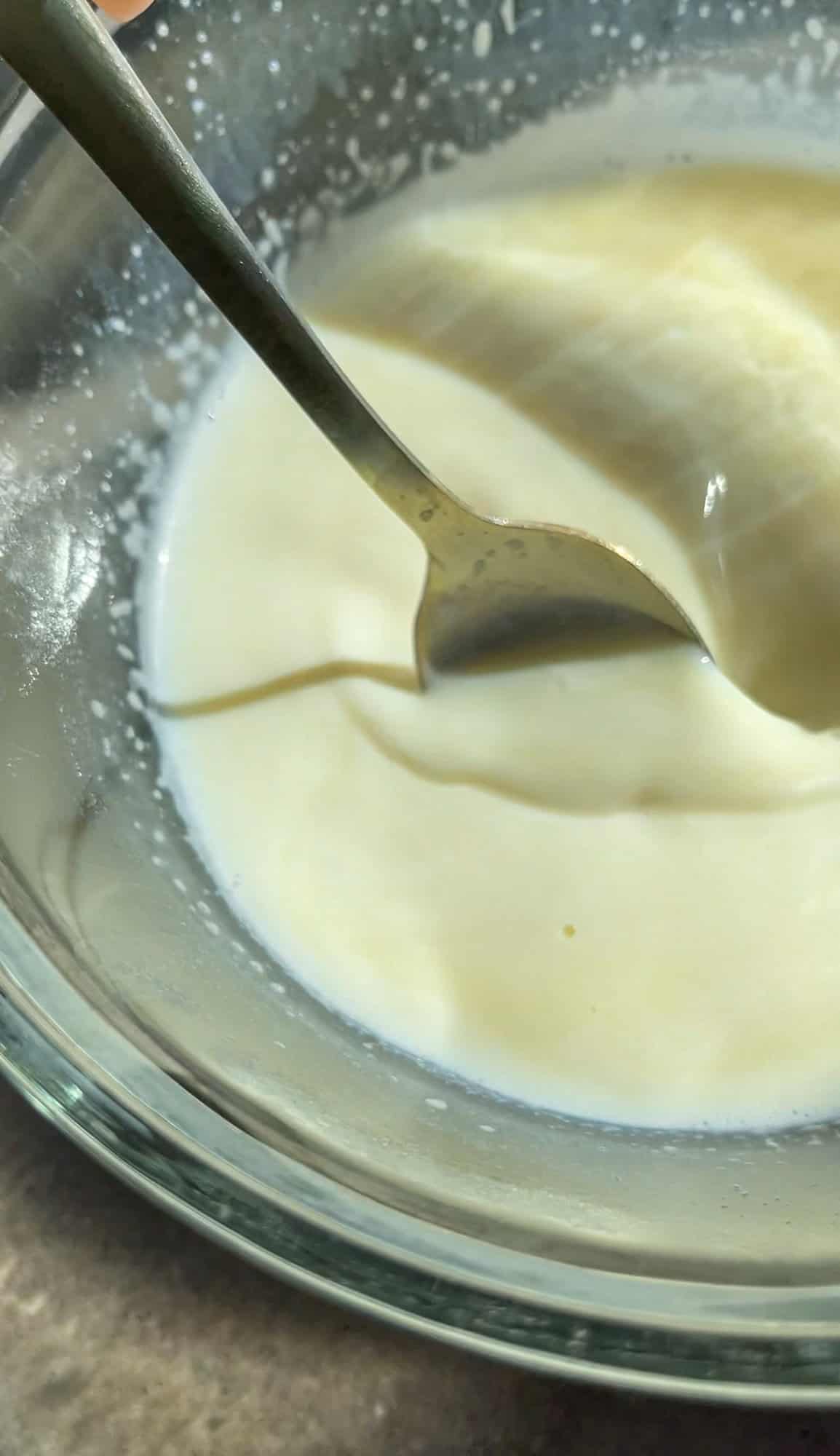 pouring hot milk over the white chocolate