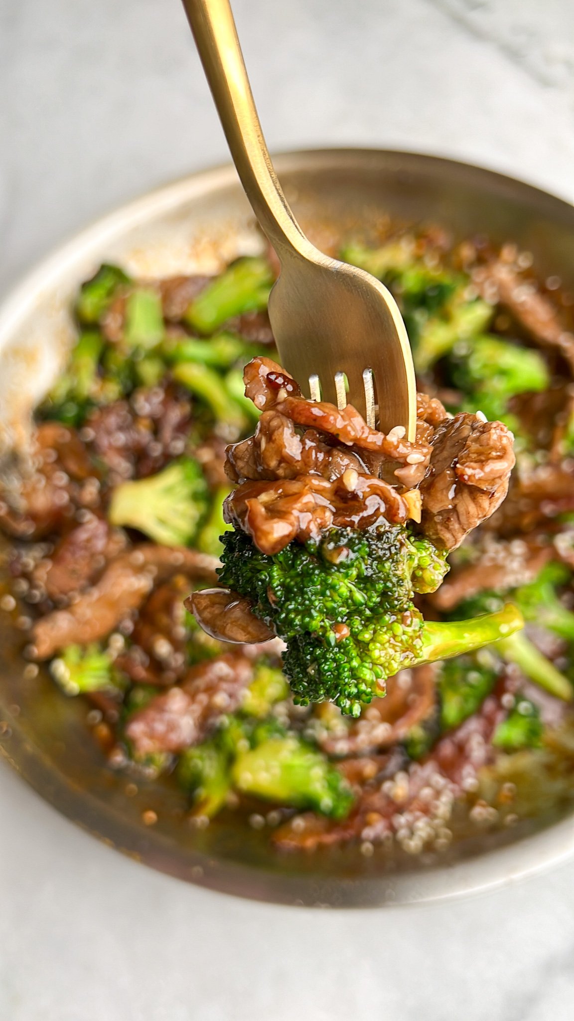 tender beef and broccoli on a fork